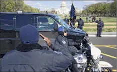  ?? Jose Luis Magana / Associated Press ?? With the U.S. Capitol in the background, U.S. Capitol Police officers salute as procession carries the remains of a U.S. Capitol Police officer who was killed after a man rammed a car into two officers at a barricade in Washington on Friday.