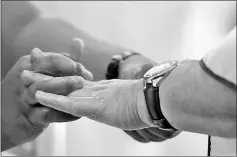  ??  ?? This photograph taken on Oct 12, 2017 shows a male hairdresse­r giving a hand massage to a customer at a men’s salon in Islamabad.