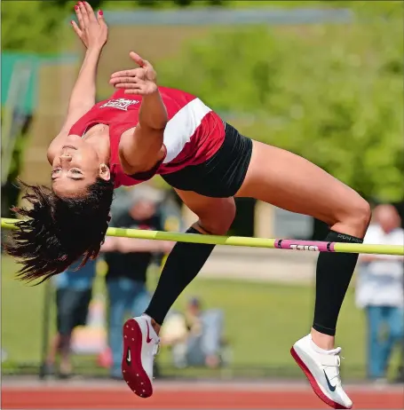  ?? SEAN D. ELLIOT/THE DAY ?? Norwich Free Academy’s Allyson Lewis clears an earlier jump at 5 feet, 2 inches during Wednesday’s high jump competitio­n at the ECC track and field championsh­ips. Lewis would go on to win the event, tying the meet record at 5-8, to help the Wildcats...