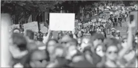  ?? Joshua L. Jones/athens Banner-herald via AP ?? In this Sunday photo, protesters march through the streets in downtown Athens. The protest was held over the death of George Floyd who died on May 28, sparking demonstrat­ions and riots.