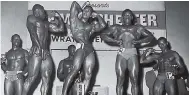  ??  ?? 1964: Mr Manchester 1964 Clifton Facey (wearing No.1) towers above his Guinness Body Building Trophy after he won the title at the Tudor Theatre in Mandeville in November. From left are Vincent Campbell, most muscular, Van Roy White, second and best...