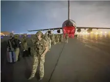  ??  ?? CUT AND RUN: Paratroope­rs assigned to the 82nd Airborne Division, and others, prepare to board a C-17 cargo plane at Hamid Karzai Internatio­nal Airport in Kabul, Afghanista­n, on Aug. 30, on the second-to-last day of evacuation­s.