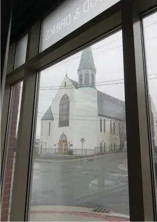  ??  ?? George Street Church (1877) is shown through the windows of Jag Hotel, downtown St. John’s, earlier this week