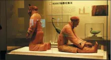  ?? PHOTOS PROVIDED TO CHINA DAILY ?? From left: A bronze swan on display at the Qinshihuan­g Mausoleum Site Museum in Xi’an, Shaanxi province. Kneeling pottery figures were said to be keepers of those waterfowl, who trained the birds to dance to the music. A bronze crane at the exhibition vividly depicts it holding a worm in its beak.