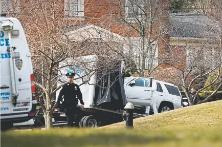  ?? Spencer Platt, Getty Images ?? A Cadillac SUV reported to have been owned by reputed mob boss Francesco Cali is removed from in front of his home after he was gunned down Wednesday night.