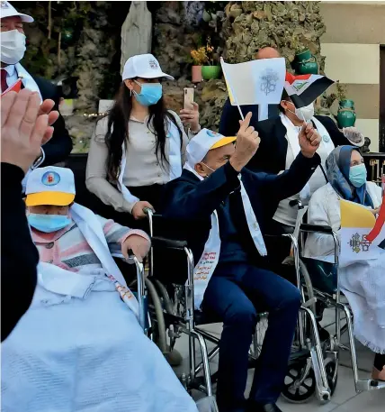  ?? AFP ?? Pope francis greeting disabled people in front of the syro-Catholic Cathedral of our lady of salvation (sayidat al najat) in Baghdad. —