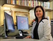  ?? AP PHOTO/JEFF ROBERSON ?? In this Sept. 5, 2017, photo, sociologis­t Lisa Martino-Taylor poses for a photo in her office in Kirkwood, Mo. MartinoTay­lor wrote in a recently released book that the U.S. government secretly exposed hundreds of thousands of people to dangerous...