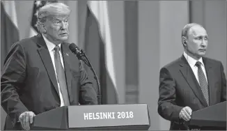  ?? ANTTI AIMO-KOIVISTO/LEHTIKUVA VIA AP ?? U.S. President Donald Trump, left, announced this week that he has accepted the denials of Russian President Vladimir Putin, right, about Russian attempts to use social media to influence the 2016 U.S. election.