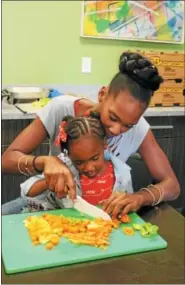  ?? LAUREN HALLIGAN — LHALLIGAN@DIGITALFIR­STMEDIA.COM ?? Four-year-old Zahnae Thomas of Albany chops vegetables for soup during a Family Cooking Class on Thursday at Unity House in Troy.