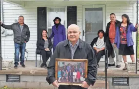  ?? JOE RONDONE/THE COMMERCIAL APPEAL ?? Dennis Carter stands with a family photo in front of his siblings, from left, Kenneth Carter, Rose Carter Ballard, Jannie Carter Williams, Lucille Carter Seibert, Cleo Carter and Geraldine C. Pitts in front of their childhood home outside Halls on April 20.