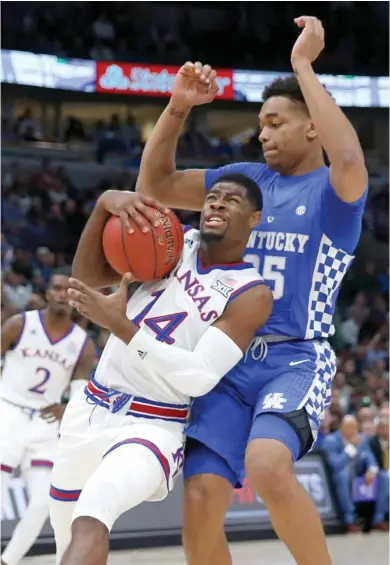  ?? (Photo by Charles Rex Arbogast, AP) ?? Kansas guard Malik Newman (14) drives on Kentucky forward PJ Washington during the first half of Tuesday's game.