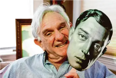  ?? Jessica Christian/The Chronicle ?? Landmark Theatres co-founder Gary Meyer, holding a Buster Keaton mask at his home in Oakland, will be honored with the Mel Novikoff Award, named for the fellow movie booster he met as a teen.