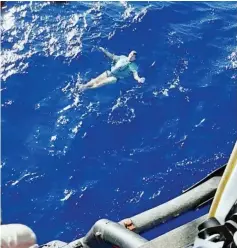  ??  ?? A man who used his jeans as a makeshift flotation device, after being knocked off a yacht and stranded at sea, is rescued by a helicopter, off Tolaga Bay in Gisborne, New Zealand, in this still from a handout video. — Reuters photo