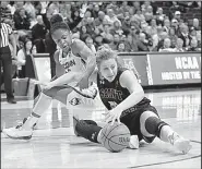  ?? AP/WILLIAMS PAUL ?? Saint Francis Guard Haley Thomas (51) and Connecticu­t Huskies Guard Crystal Dangerfiel­d (5) battle for the loose ball during the Huskies 140-52 victory on Saturday in Storrs, CONN.