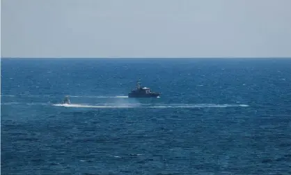  ??  ?? A Guardia di Finanza boat is seen in the Mediterran­ean after a rescue boat caught fire. Photograph: Remo Casilli/Reuters