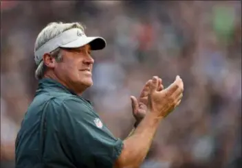  ?? MICHAEL PEREZ — THE ASSOCIATED PRESS ?? Eagles coach Doug Pederson had reason to applaud during practice Sunday night. Earlier in the day he and Howie Roseman, the vice president of football operations, had their contracts extended through 2022.