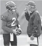  ??  ?? Memphis Express quarterbac­k Johnny Manziel chats with coach David Lee (right) during a recent practice at the Liberty Bowl Memorial Stadium. MARK WEBER/THE COMMERCIAL APPEAL