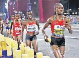  ??  ?? Ruth Chepngetic­h of Kenya (right) said ‘training in a hot area’ helped her tame the elements after claiming gold in women’s marathon at the World Athletics Championsh­ips at Doha on Saturday.
AP