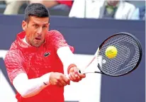  ?? GREGORIO BORGIA/ASSOCIATED PRESS FILE PHOTO ?? Serbia's Novak Djokovic returns the ball to Denmark's Holger Rune on May 17 during their quarterfin­al match at the Italian Open in Rome. Djokovic is seeded No. 3 in the upcoming French Open and may face top-seeded Carlos Alcaraz in the semifinals.