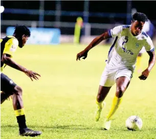  ?? IAN ALLEN ?? Waterhouse’s Stephen Williams (right) dribbles away from Peterson Pierre (left) of Don Bosco from during their Concacaf Caribbean Club Championsh­ips match at the Anthony Spaulding Sport Complex, yesterday.