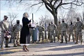  ?? (AP Photo/Jacquelyn Martin, Pool) ?? First lady Jill Biden surprises National Guard members outside the Capitol with chocolate chip cookies Friday in Washington.