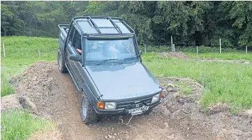  ?? ?? Negotiatin­g a tricky part of the course in a Land Rover.