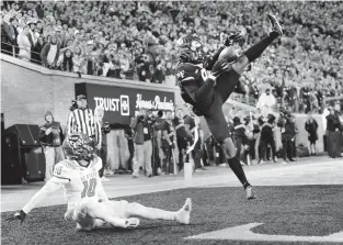  ?? WALT UNKS/AP ?? Wake Forest wide receiver A.T. Perry makes a touchdown catch against N.C. State safety Tanner Ingle during the first quarter Saturday night.