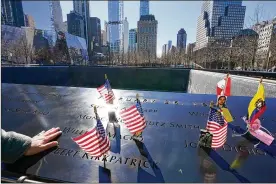  ?? MARY ALTAFFER / AP ?? Sgt. Edwin Morales pays his respects to the six victims of the 1993 bombing at the World Trade Center before the start of a ceremony Friday marking the 28th anniversar­y of the attack in New York.