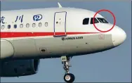  ?? WAN BI / XINHUA ?? Sichuan Airlines Flight 3U8633 prepares to land in Chengdu with a damaged cockpit windshield (circle) on Monday.