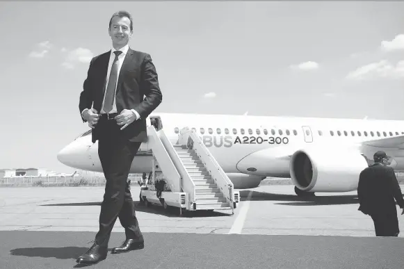  ?? CHRISTOPHE MORIN/BLOOMBERG ?? Guillaume Faury, Airbus president of commercial aircraft, helps introduce Tuesday the A220, which was rebranded from Bombardier’s C Series jet, in Toulouse, France. The European airplane maker, which took a majority stake in the C Series program...