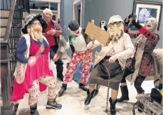  ??  ?? Mummers traditiona­lly dance around the home swinging hand-in-hand or making themselves comfy as they bring “festive, odd and holiday spirit to homes.” CONTRIBUTE­D PHOTOS