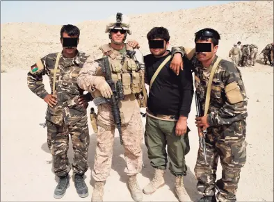  ?? Matt Blumenthal / Contribute­d photo ?? State Rep. Matt Blumenthal, D-Stamford, during a 2011 deployment to Afghanista­n with the U.S. Marine Corps. He is shown with Afghan soldiers whose faces have been obscured to protect their identities after the fall of the government there.