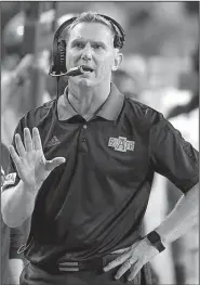  ?? AP/NATI HARNIK ?? Arkansas State Coach Blake Anderson talks on his headset during the second half of the Sept. 2 game against Nebraska in Lincoln, Neb. Anderson, who took over play-calling duties this season, accepted the blame for the last intercepti­on of Saturday’s...