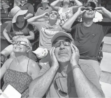  ?? SHELLEY MAYS, THE (NASHVILLE) TENNESSEAN ?? Ken Abraham and his wife, Lisa, take in the sky show from Nashville’s viewing party at First Tennessee Park.