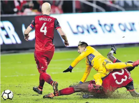  ?? FRANK GUNN/THE CANADIAN PRESS ?? Toronto FC defender Chris Mavinga, right, tackles UANL Tigres forward Ismael Sosa during the second half of the teams’ CONCACAF Champions League quarter-final match in Toronto on Wednesday. The teams play the second leg Tuesday in Monterrey, Mexico.