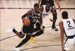  ?? KIM KLEMENT - THE ASSOCIATED PRESS ?? Brooklyn Nets guard Caris LeVert (22) dribbles the ball against Los Angeles Clippers guard Reggie Jackson (1) in the first half of an NBA basketball game Sunday, Aug. 9, 2020, in Lake Buena Vista, Fla.