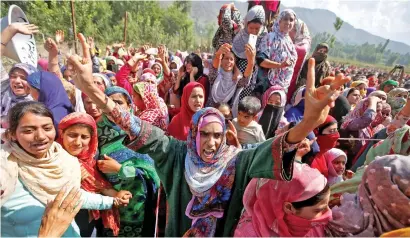  ?? Reuters ?? Women mourn during the funeral of Adil Ahmad, a suspected militant, who was killed in a gunbattle with security forces at Midoora village in south Kashmir’s Pulwama district on Wednesday. —