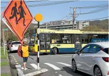  ??  ?? Bus drivers have to perform a three point turn before-reversing into the Ariki St bus stop outside Boulcott School in Lower Hutt.