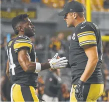 ??  ?? Ben Roethlisbe­rger, right, blames himself for the slow start of Pittsburgh Steelers teammate Antonio Brown, left. Last weekend, Brown had just 62 yards receiving on five catches on 11 targets.