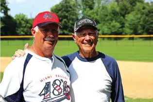  ??  ?? ABOVE: Dick Pavlak, 83, pitches during a baseball game June 15 at Schoolhous­e Park in Centervill­e, Ohio. Pavlak plays with his son, Randy, for the Miami Valley 48s team in the M.V. Roy Hobbs League-Masters Division.
LEFT: Dick Pavlak right, stands...