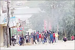  ?? ?? Public transport workers protesting at the Four-Way Stop, which leads to the Manzini Magistrate­s Court, where they also blocked the road and started a fire.