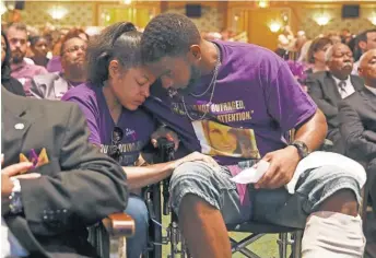  ?? POOL PHOTO BY ANDREW SHURTLEFF ?? Marissa Blair and her fiancé, Marcus Martin, wear purple, Heyer’s favorite color, in her memory.