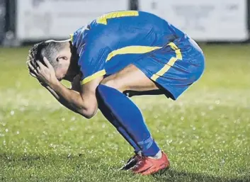  ??  ?? Jordan Nicholson has his head in his hands after missing the crucial Sports penalty. Photo: James Richardson.