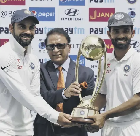  ??  ?? 0 India captain Virat Kohli, left, Ajinkya Rahane, right and Sunil Gavaskar, centre, with the Border-gavaskar Trophy.