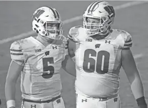  ?? MARK HOFFMAN / MILWAUKEE JOURNAL SENTINEL ?? UW tackle Logan Bruss, right, has started 25 games for the Badgers and has become a more consistent­ly vocal leader.