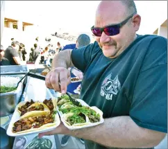  ?? Dan Watson/The Signal ?? (Above) Joe Zamora prepares tacos for his family at the taco bar Saturday during the Golden Valley High School Quinceañer­a, celebratin­g 15 years of growth and excellence held at Golden Valley High School in Santa Clarita.