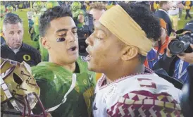  ?? Mark J. Terrill/Associated Press ?? Oregon’s Marcus Mariota, left, and Florida State’s Jameis Winston are likely to be drafted in the first 10 picks.