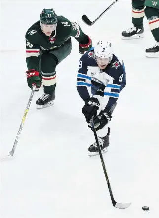  ?? HANNAH FOSLIEN/GETTY IMAGES ?? Winnipeg Jets forward Andrew Copp, seen keeping the puck from Minnesota Wild defenceman Nick Seeler on Sunday in St. Paul, Minn., says there are “no real excuses” for their Game 3 loss.