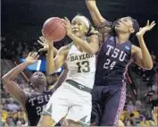  ?? Jerry Larson Associated Press ?? NINA DAVIS of Baylor drives between Artavia Ford (24) and Breasia McElrath of Texas Southern.