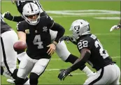  ?? ETHAN MILLER — GETTY IMAGES, FILE ?? Raiders quarterbac­k Derek Carr hands the ball off to running back Josh Jacobs during the first half against the Buccaneers at Allegiant Stadium on Oct. 25.